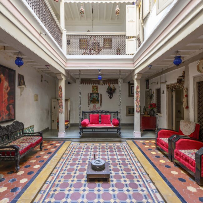 1. Chowk or courtyard of Jagdip Mehta's Heritage House with the traditional features of open skylight and swing bed-min